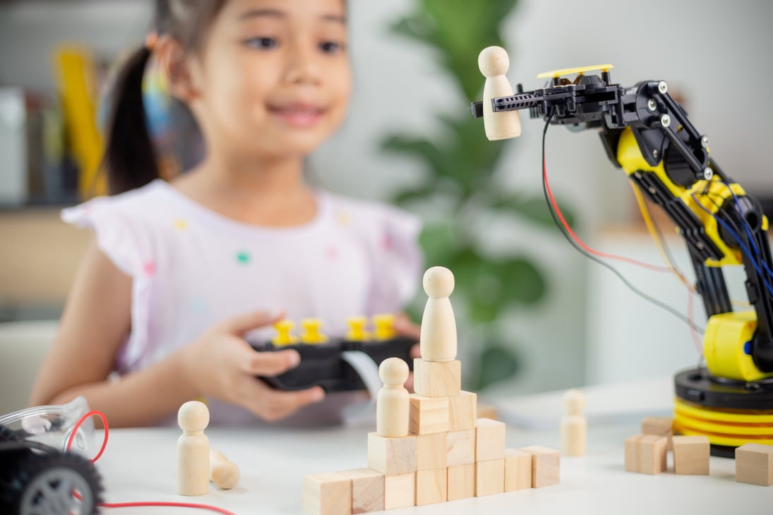 STEM education concept. Asian students learn at home by coding robot arms in STEM, mathematics engineering science technology computer code in robotics for kids' concepts